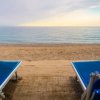 Due lettini blu fronte mare al tramonto.