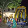 Persone e giochi gonfiabili di notte in piazza.